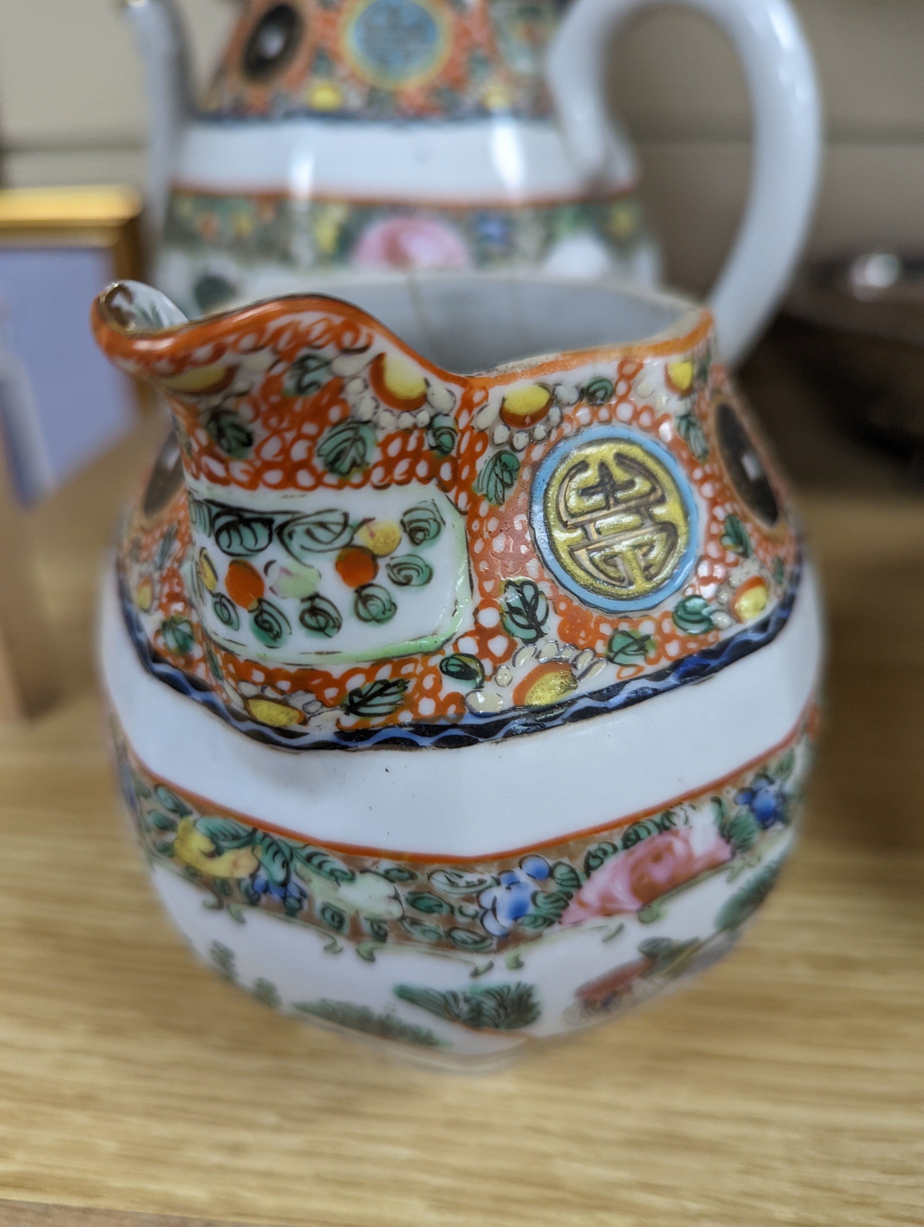 A Chinese celadon glazed vase, 24cm and a Chinese famille rose teapot and matching cream jug, a.f.